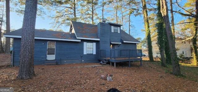 back of house featuring a wooden deck