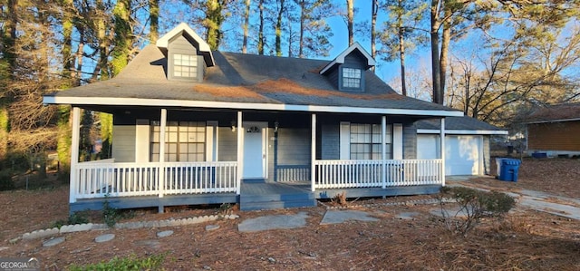 view of front of house featuring a porch and a garage