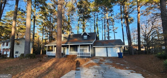 view of front of home with a porch and a garage