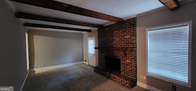 unfurnished living room with beam ceiling, a fireplace, and carpet