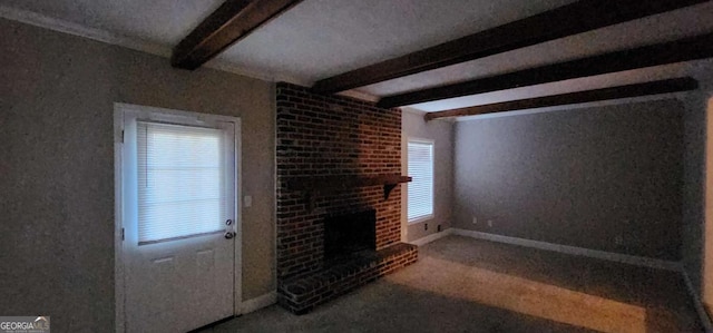 unfurnished living room with carpet flooring, beam ceiling, and a brick fireplace