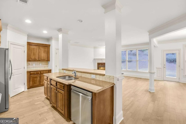 kitchen with crown molding, sink, light hardwood / wood-style flooring, decorative backsplash, and appliances with stainless steel finishes