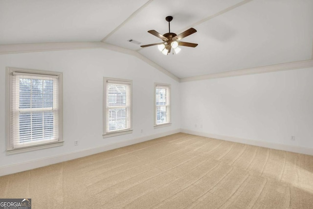 unfurnished room featuring light colored carpet, vaulted ceiling, and ceiling fan