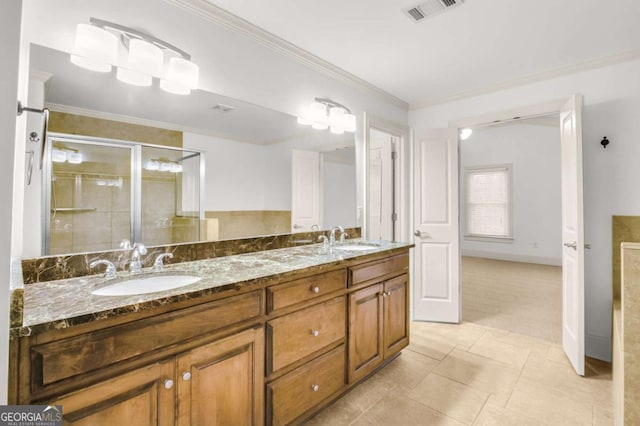 bathroom with tile patterned flooring, vanity, ornamental molding, and a shower with door