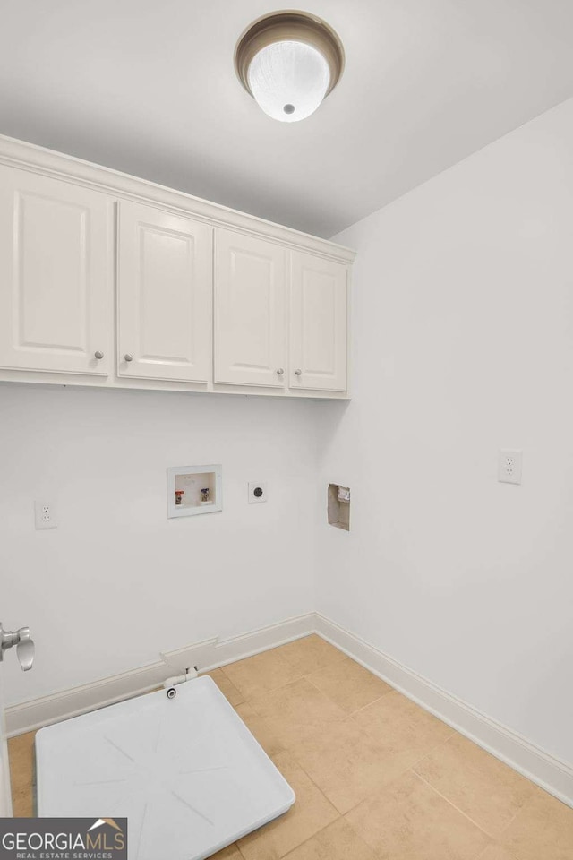 laundry area with hookup for an electric dryer, light tile patterned floors, cabinets, and washer hookup