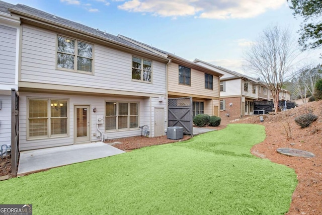 back of property featuring a lawn, cooling unit, and a patio