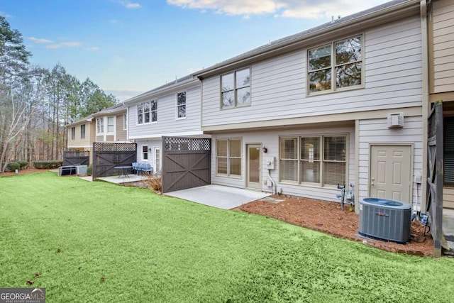 back of property featuring a yard, a patio, and central AC