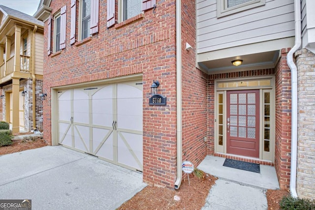 doorway to property with a garage