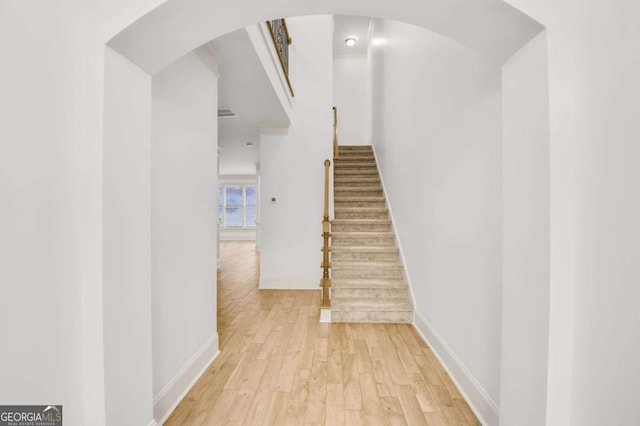 stairs featuring hardwood / wood-style floors