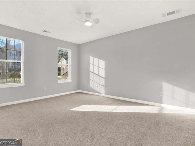 spare room featuring carpet and ceiling fan