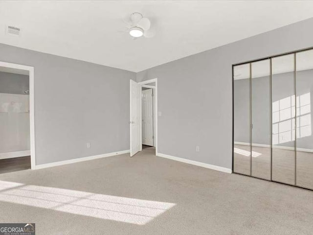 unfurnished bedroom featuring carpet and a closet