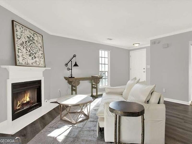 living room featuring dark wood-type flooring and ornamental molding