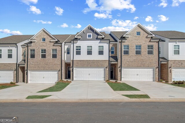 view of front of house featuring a garage and a front lawn