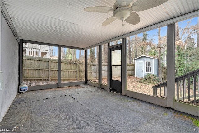 unfurnished sunroom featuring ceiling fan