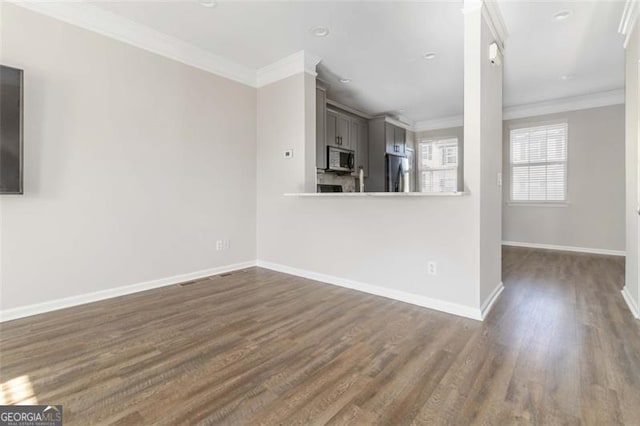 unfurnished living room featuring dark hardwood / wood-style floors and crown molding