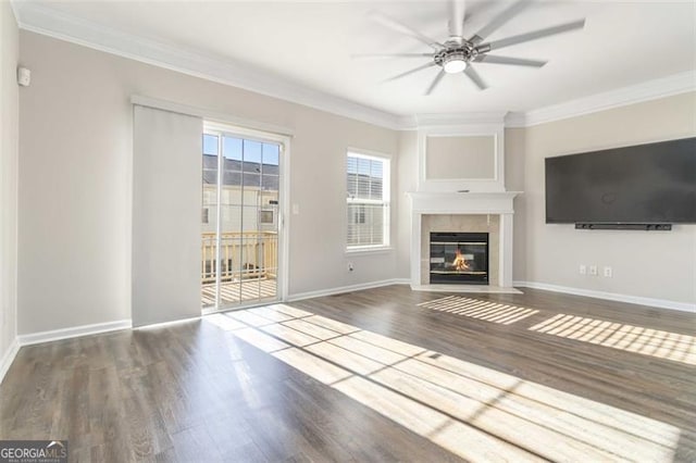 unfurnished living room with crown molding, ceiling fan, and dark hardwood / wood-style floors