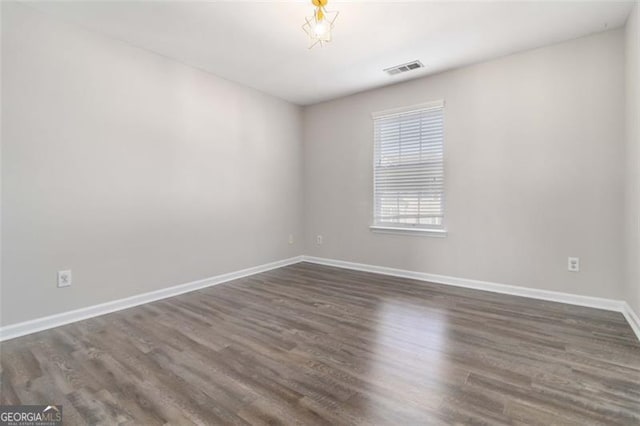 unfurnished room featuring dark hardwood / wood-style floors