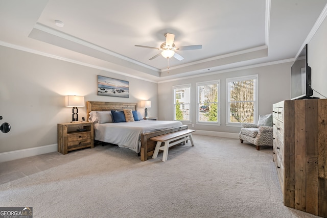 bedroom featuring a raised ceiling, ceiling fan, crown molding, and light colored carpet