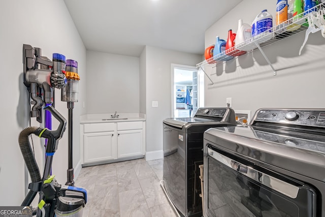 washroom with separate washer and dryer, cabinets, and sink