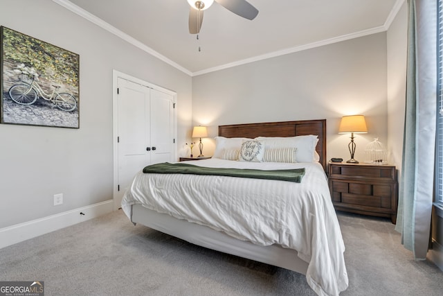 bedroom featuring carpet flooring, ornamental molding, ceiling fan, and a closet