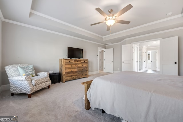 bedroom with ceiling fan, crown molding, light carpet, and a tray ceiling