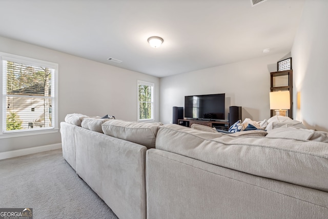 living room featuring light carpet and plenty of natural light