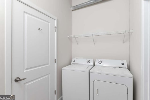 laundry room featuring washing machine and clothes dryer