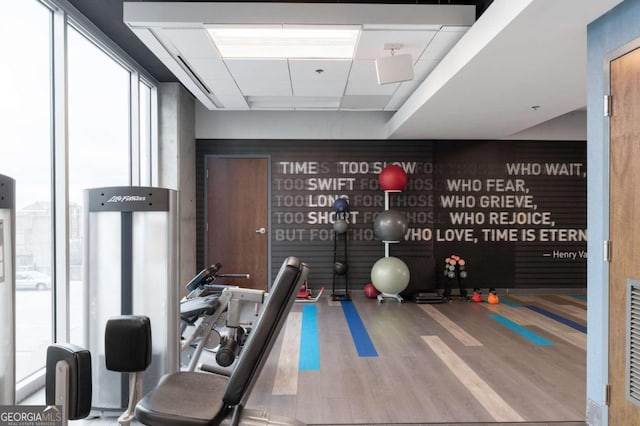 exercise room with hardwood / wood-style floors