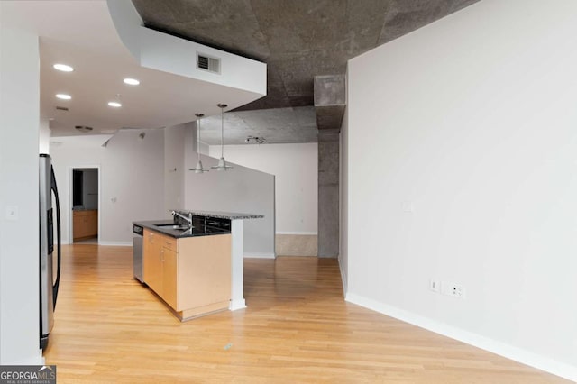 kitchen with sink, light wood-type flooring, and appliances with stainless steel finishes