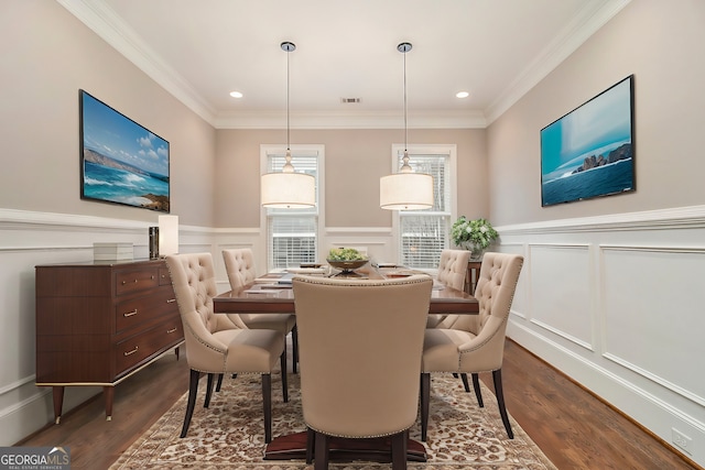 dining space featuring dark wood-type flooring and ornamental molding