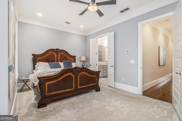 carpeted bedroom with crown molding, ensuite bath, and ceiling fan