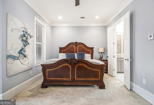 bedroom featuring crown molding, light colored carpet, and ensuite bathroom