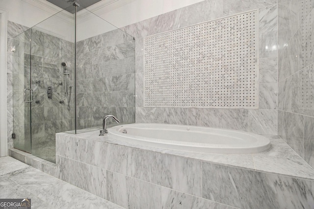 bathroom with ornamental molding and separate shower and tub