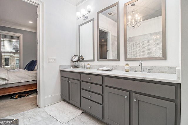 bathroom with vanity, crown molding, and an inviting chandelier