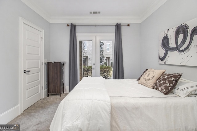 carpeted bedroom with ornamental molding and access to exterior