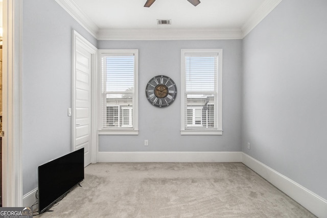 unfurnished room with light carpet, crown molding, plenty of natural light, and ceiling fan