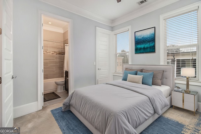 bedroom with ensuite bathroom, ornamental molding, light colored carpet, and ceiling fan