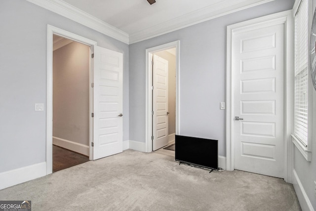 unfurnished bedroom with crown molding and light colored carpet