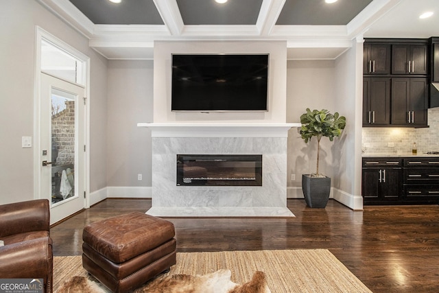 living room with dark hardwood / wood-style floors, beamed ceiling, ornamental molding, coffered ceiling, and a premium fireplace