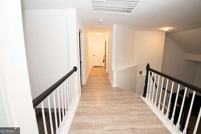 corridor with light hardwood / wood-style flooring