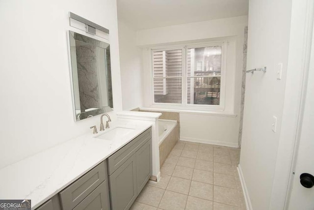 bathroom featuring tile patterned flooring, vanity, and a bathing tub