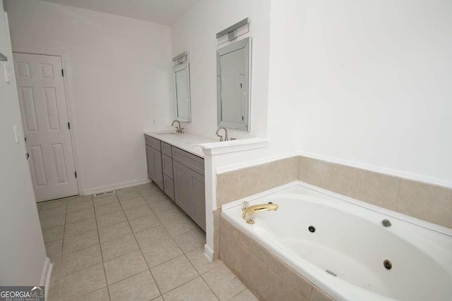 bathroom featuring tile patterned flooring, vanity, and a relaxing tiled tub