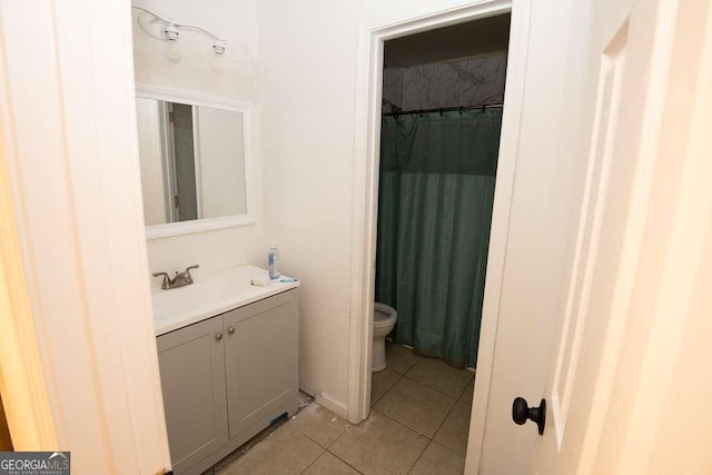 bathroom featuring tile patterned flooring, vanity, and toilet