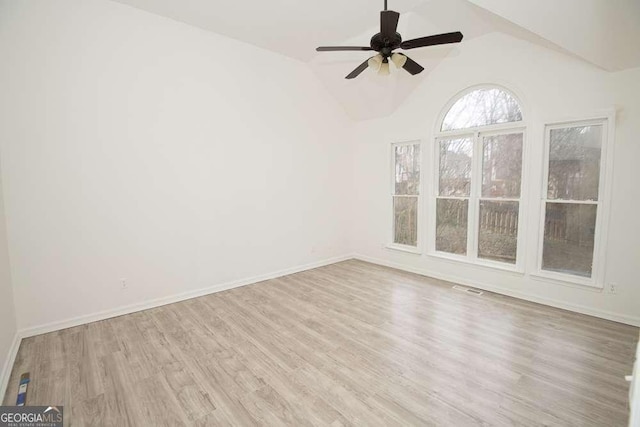 empty room with light wood-type flooring, vaulted ceiling, and ceiling fan