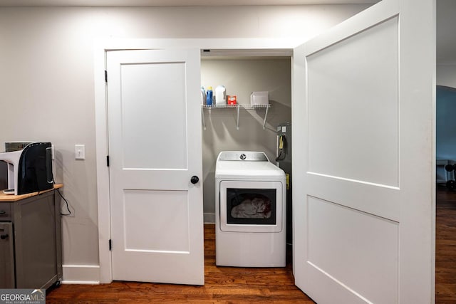 laundry room with dark wood-type flooring and washer / dryer