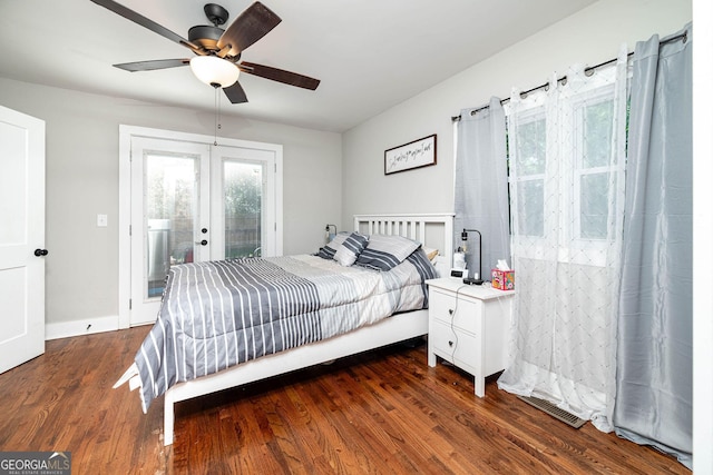 bedroom featuring french doors, dark hardwood / wood-style flooring, access to exterior, and ceiling fan