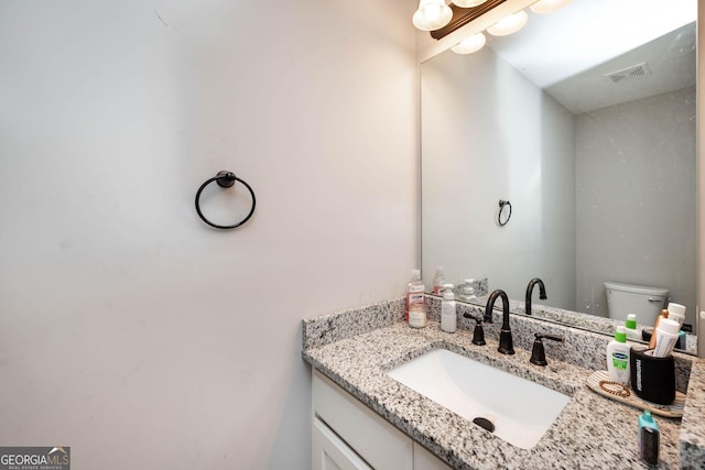 bathroom with toilet and vanity