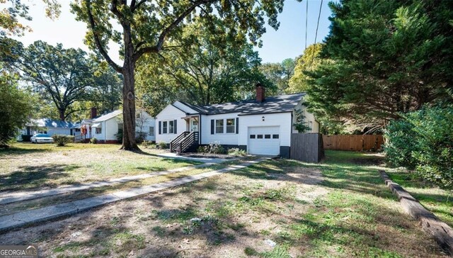 ranch-style home with a garage and a front yard