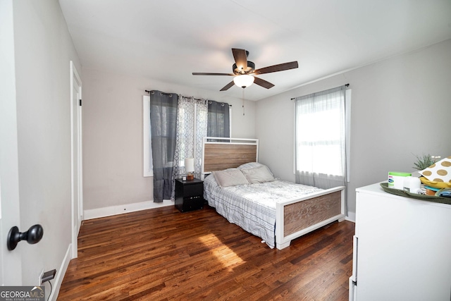 bedroom with ceiling fan and dark hardwood / wood-style flooring