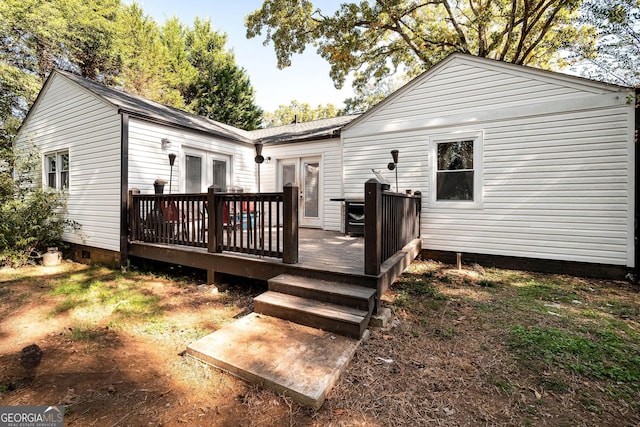 rear view of house featuring french doors and a deck